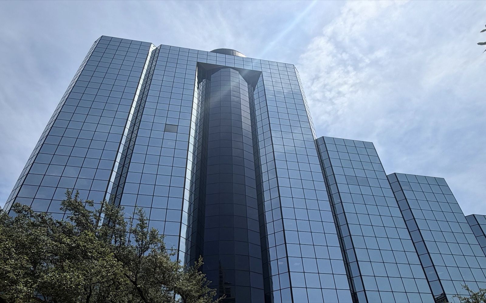 The glass office tower at 4514 Cole Avenue in Dallas